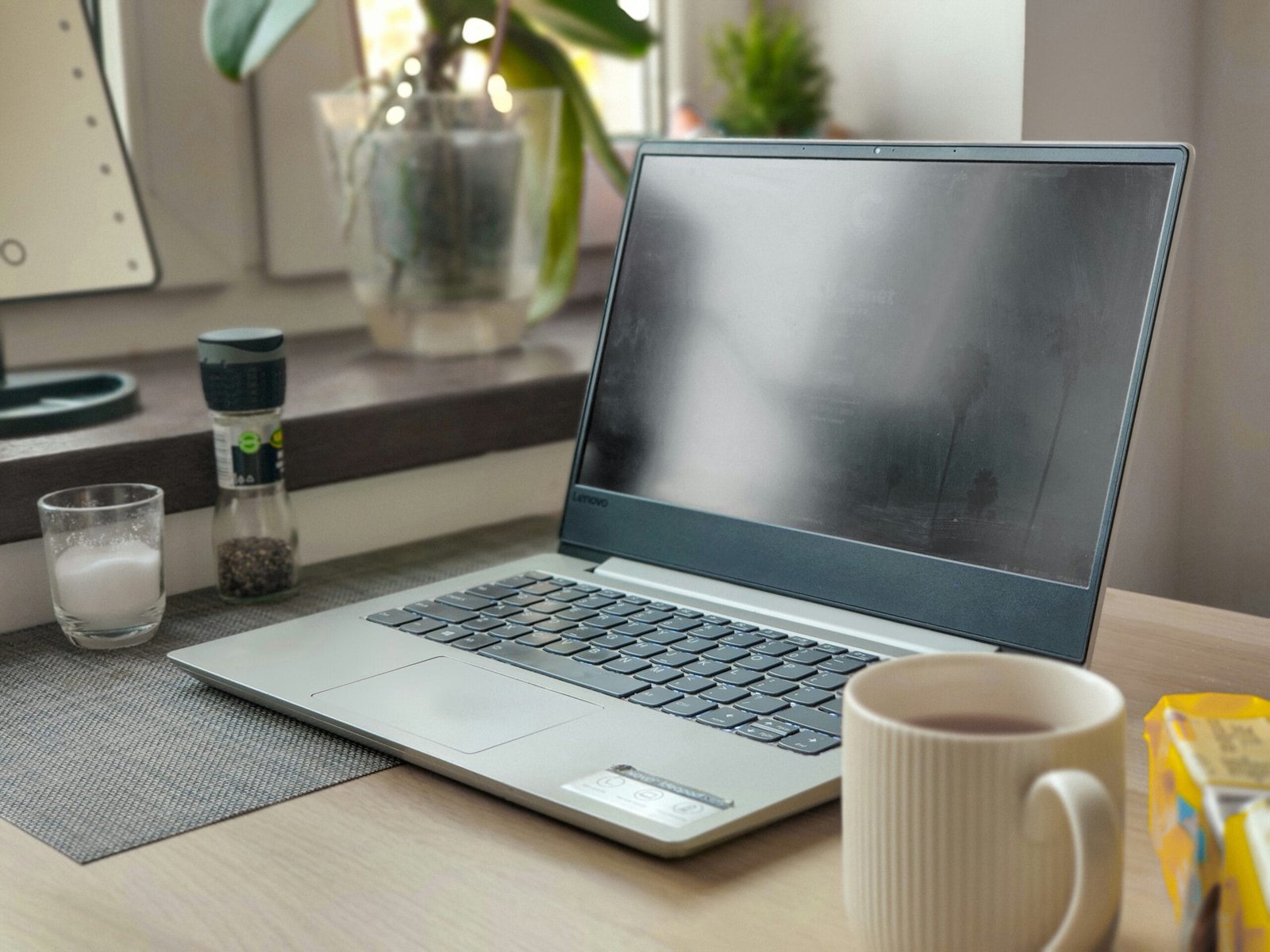 a laptop computer sitting on top of a wooden desk