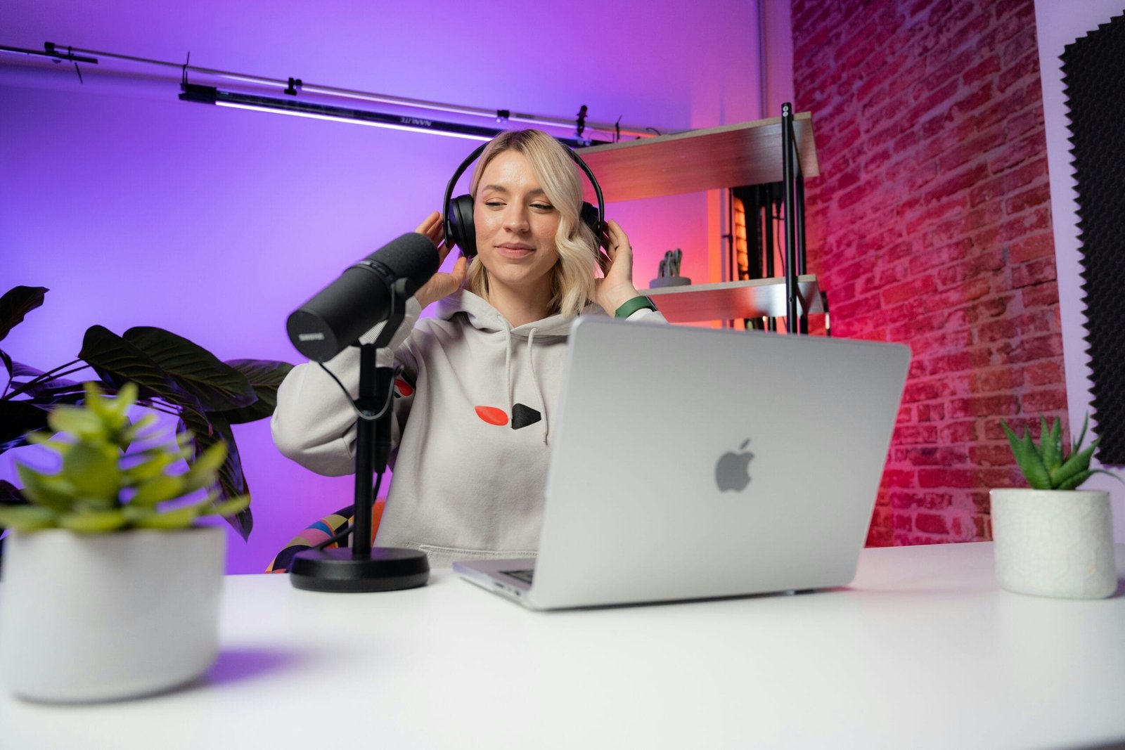 a woman sitting in front of a laptop computer